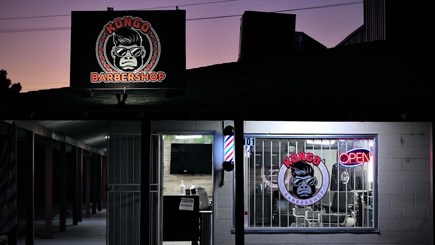 Kongo Barbershop storefront at night